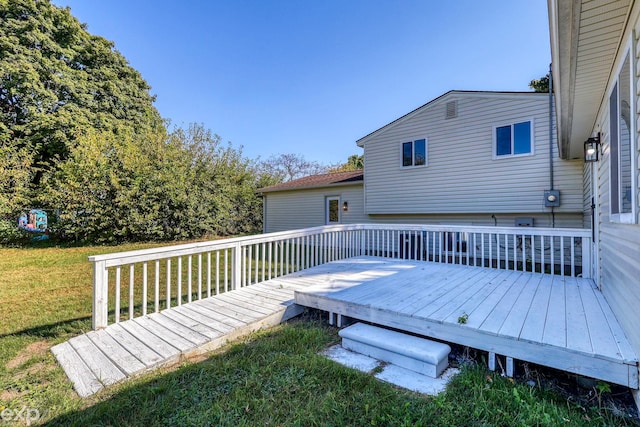 wooden terrace featuring a lawn