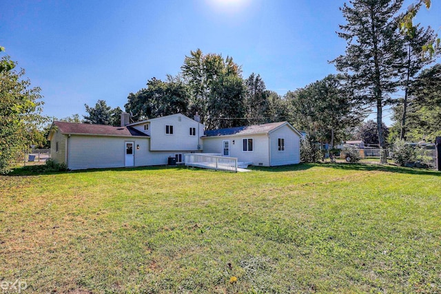 rear view of property featuring a lawn