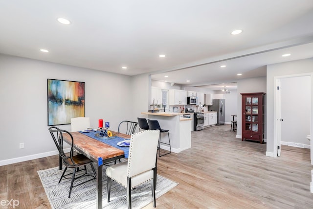 dining area with light wood-type flooring