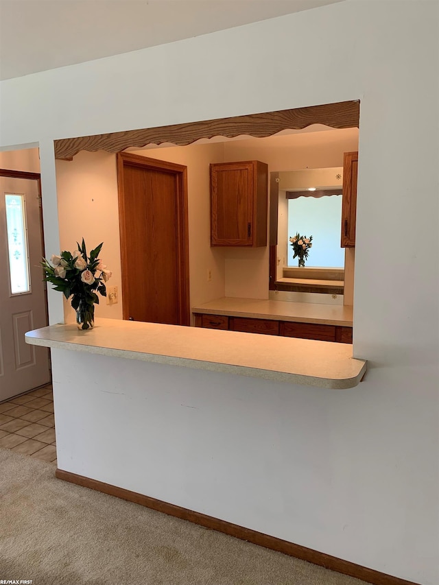 kitchen featuring light carpet