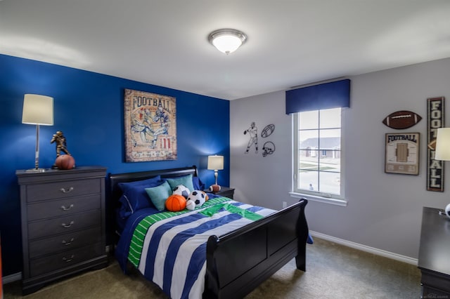 bedroom with baseboards and dark carpet