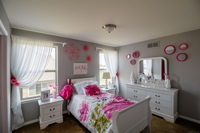 carpeted bedroom featuring multiple windows