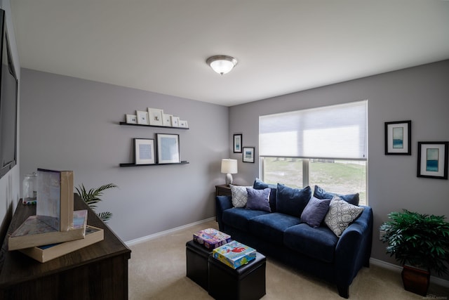 living room featuring light colored carpet and baseboards