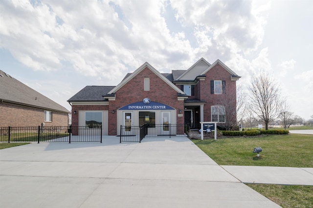 view of front facade with brick siding, roof with shingles, a front yard, and fence