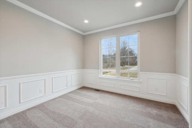 empty room featuring recessed lighting, carpet, visible vents, and ornamental molding