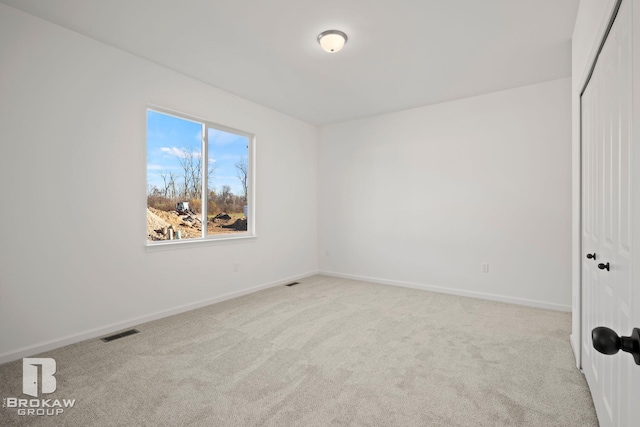 empty room featuring light carpet