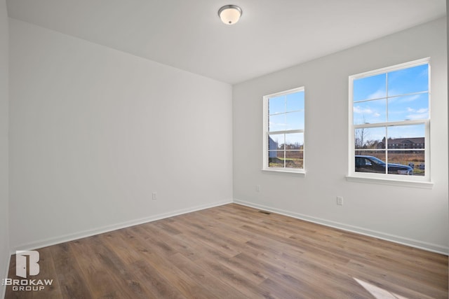 unfurnished room with hardwood / wood-style floors