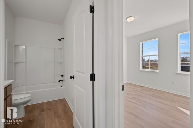 full bathroom with shower / bathing tub combination, wood-type flooring, toilet, and vanity