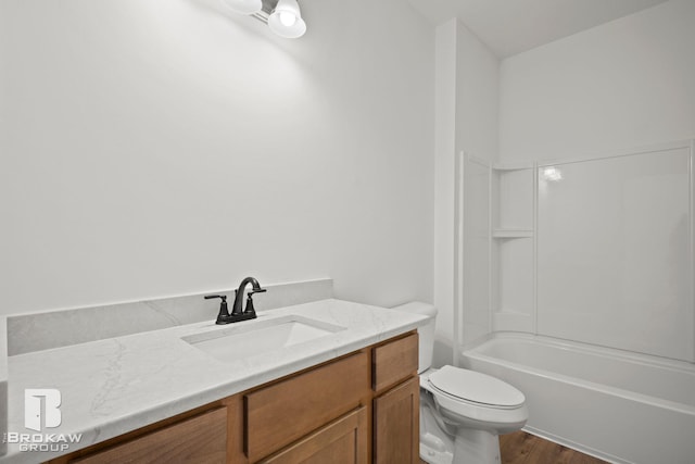 full bathroom featuring toilet, vanity, hardwood / wood-style floors, and  shower combination