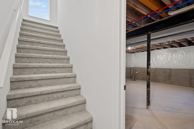 stairway with concrete flooring