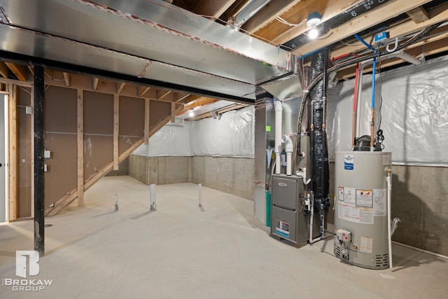 basement featuring gas water heater and heating unit