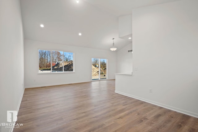 unfurnished living room featuring high vaulted ceiling and wood-type flooring