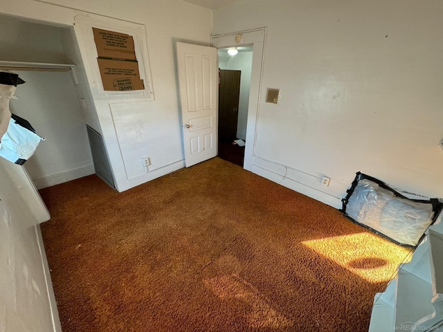 unfurnished bedroom with carpet and a closet