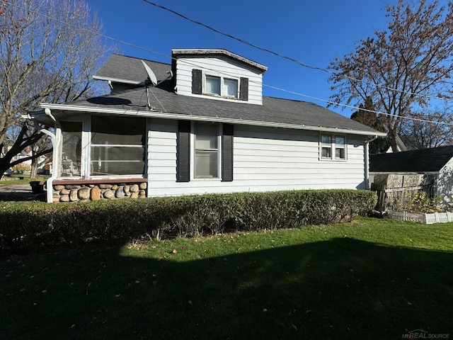 view of side of property with a yard