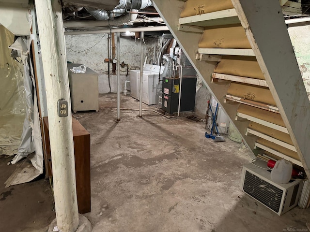 basement featuring washer and dryer and heating unit