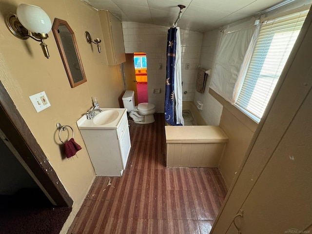 bathroom featuring a shower with curtain, wood-type flooring, vanity, and toilet