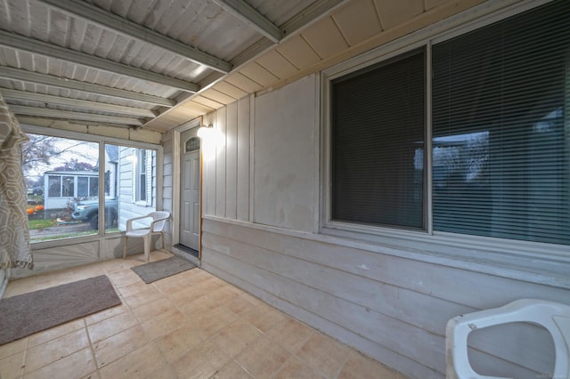 sunroom with beam ceiling and wooden ceiling