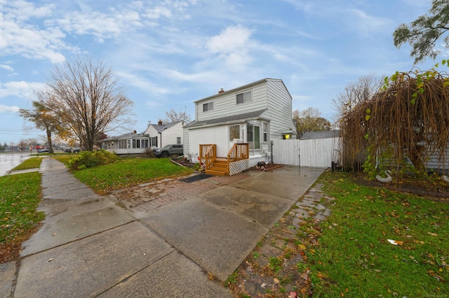 rear view of property featuring a lawn