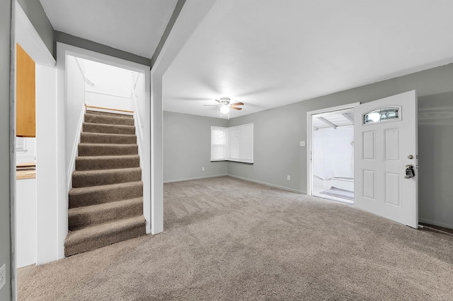 unfurnished living room featuring ceiling fan and carpet floors