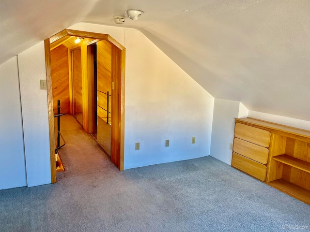 bonus room with lofted ceiling and carpet floors