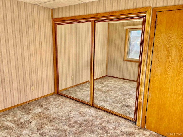 unfurnished bedroom featuring carpet floors and a closet