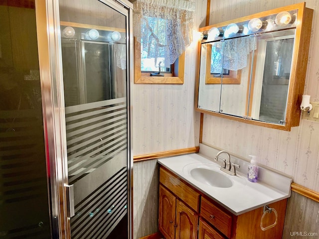 bathroom featuring wood walls, walk in shower, and vanity