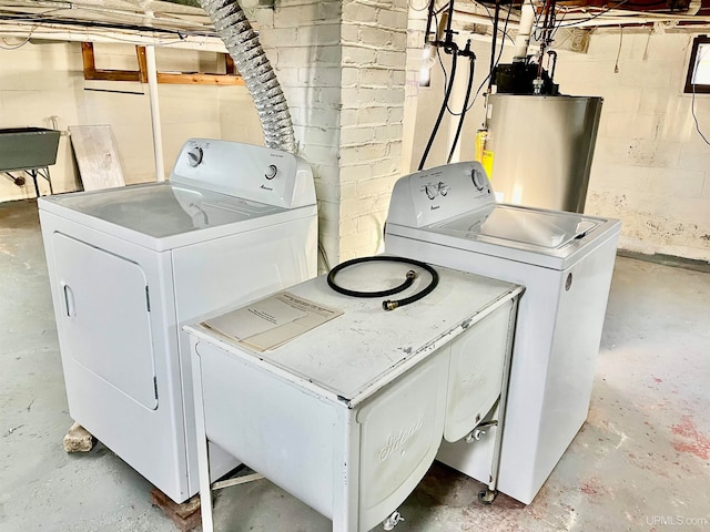 laundry room with sink, independent washer and dryer, and gas water heater