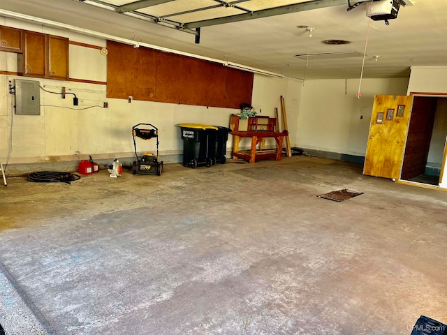 garage featuring electric panel and a garage door opener