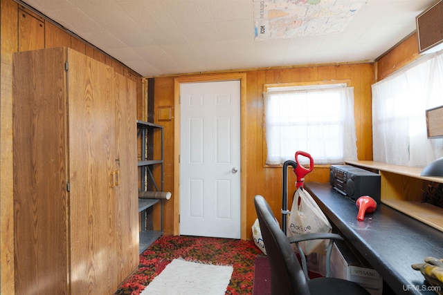 home office with wood walls and carpet flooring