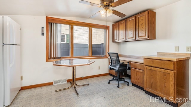 office featuring built in desk, ceiling fan, and lofted ceiling