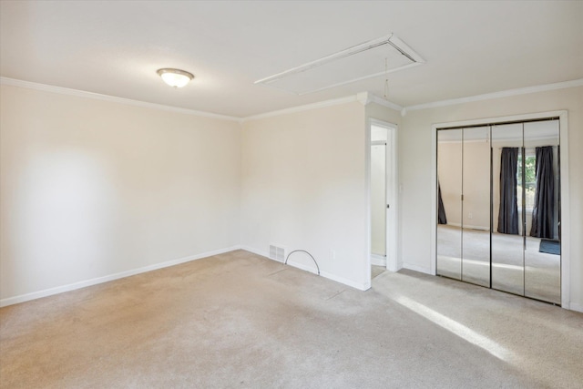 carpeted spare room featuring crown molding