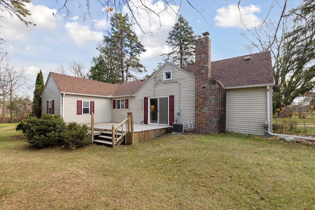 back of house featuring a deck and a yard