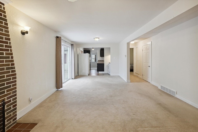 unfurnished living room featuring carpet