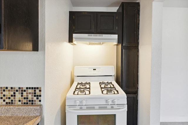 kitchen featuring tasteful backsplash and white gas range oven