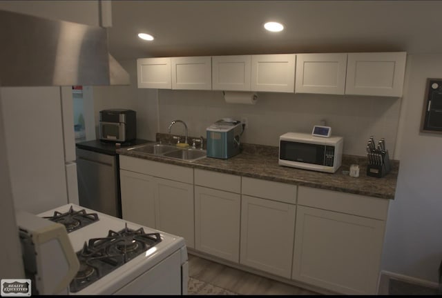 kitchen featuring white cabinetry, light hardwood / wood-style floors, sink, and white appliances