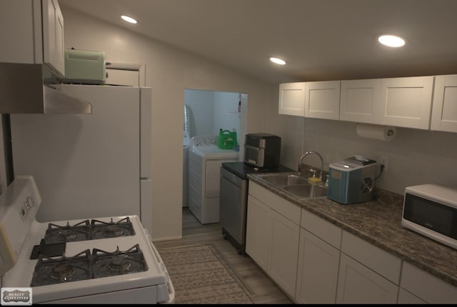 kitchen with separate washer and dryer, sink, white cabinets, white appliances, and lofted ceiling