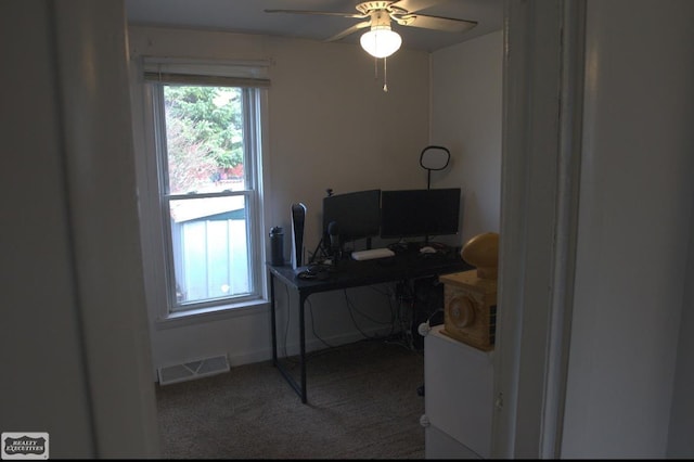 carpeted office with ceiling fan