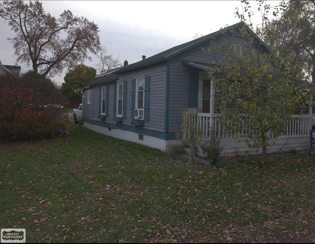 view of side of property with a yard and cooling unit