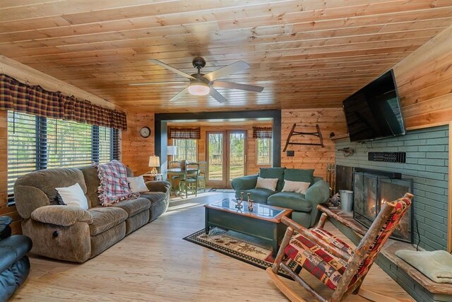 living room with wooden walls, wooden ceiling, and hardwood / wood-style flooring