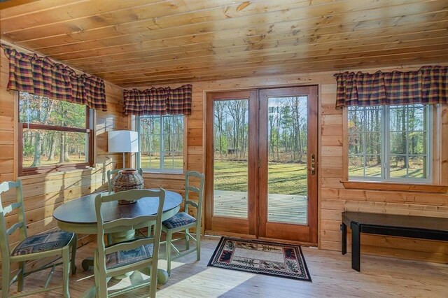 doorway featuring wooden walls, wood ceiling, and hardwood / wood-style flooring