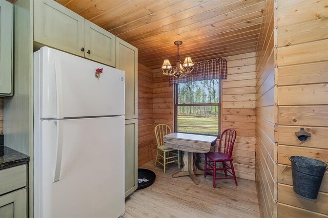 kitchen featuring light hardwood / wood-style flooring, white fridge, a notable chandelier, decorative light fixtures, and wood ceiling