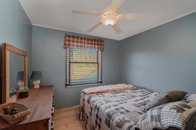 bedroom with ceiling fan, crown molding, and light wood-type flooring