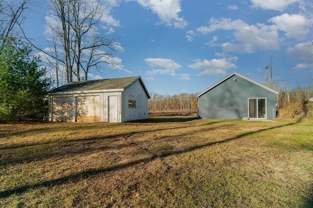 exterior space featuring a yard and an outdoor structure