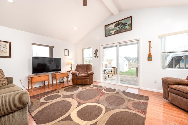 living room featuring beam ceiling, high vaulted ceiling, and light hardwood / wood-style floors