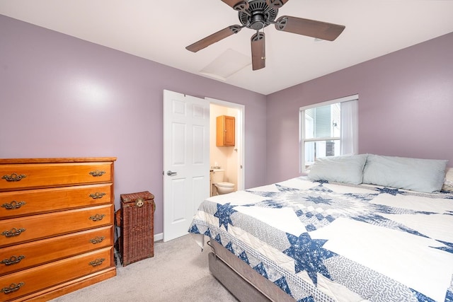 bedroom featuring ensuite bathroom, ceiling fan, and light carpet