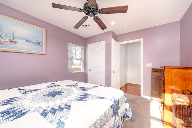 bedroom with light carpet and ceiling fan