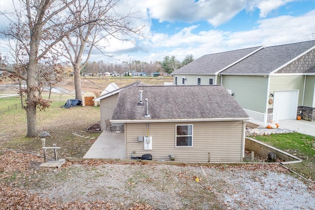 view of property exterior with a patio area and a garage