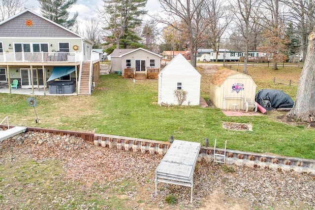 view of yard with a wooden deck, a patio area, and a shed