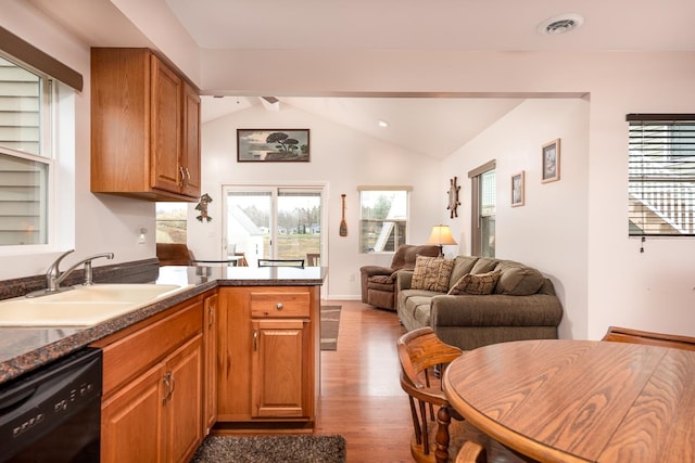 kitchen with dishwasher, lofted ceiling with beams, light hardwood / wood-style flooring, and sink