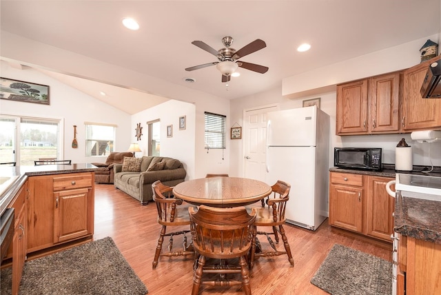 kitchen featuring vaulted ceiling, white fridge, ceiling fan, and light wood-type flooring